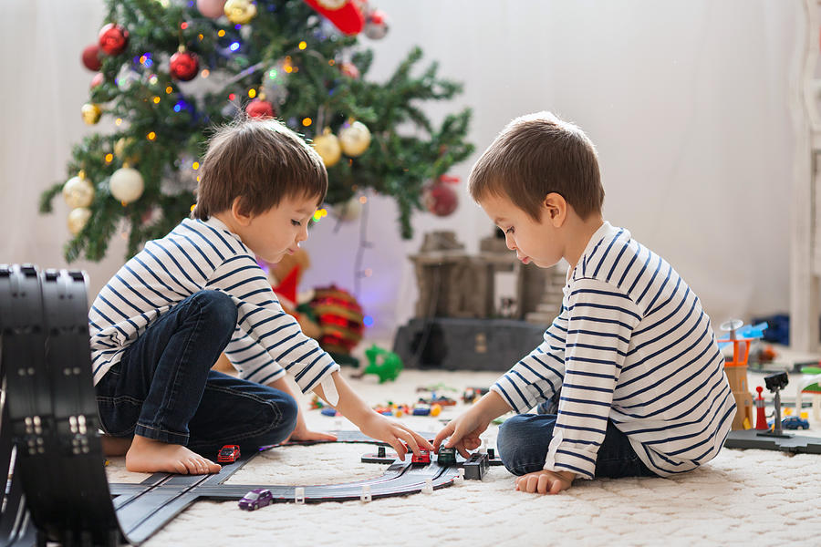 Two adorable boys, playing with toys on Christmas Photograph by Tatyana Tomsickova Photography