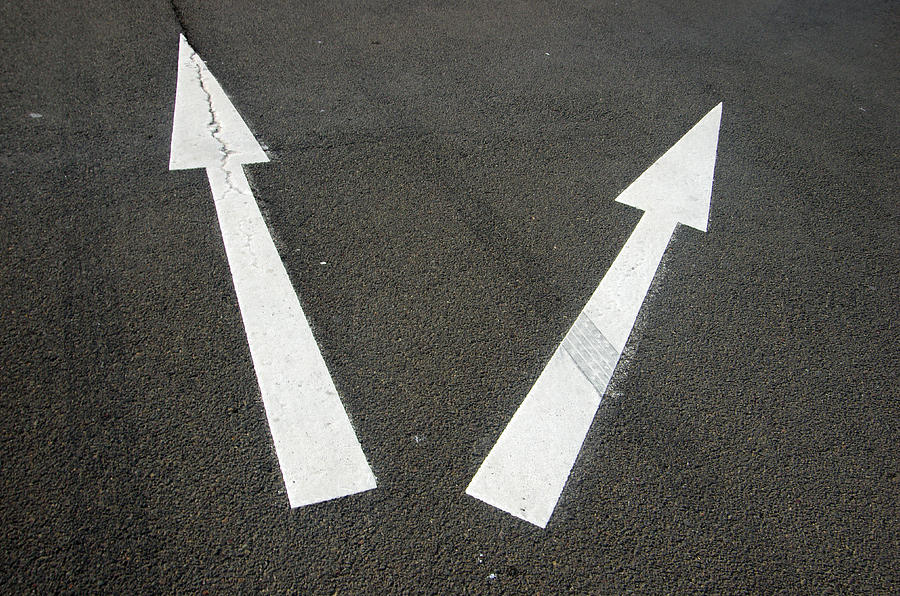 Two arrows pointing in different directions on a road Photograph by Simon McGill