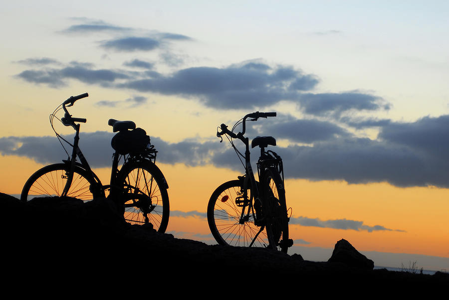 Two bikes on the mountain sunset landscape Photograph by Severija Kirilovaite