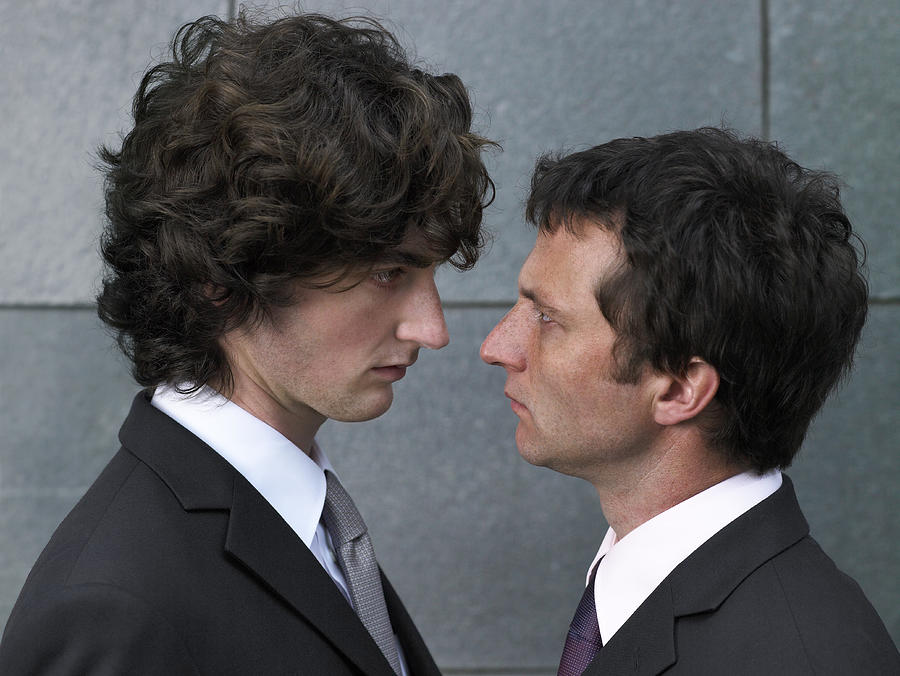 Two businessmen face to face, profile, close-up Photograph by Michael Blann