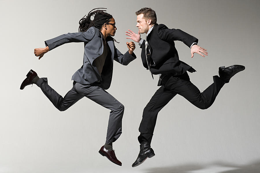 Two businessmen jumping Photograph by Image Source