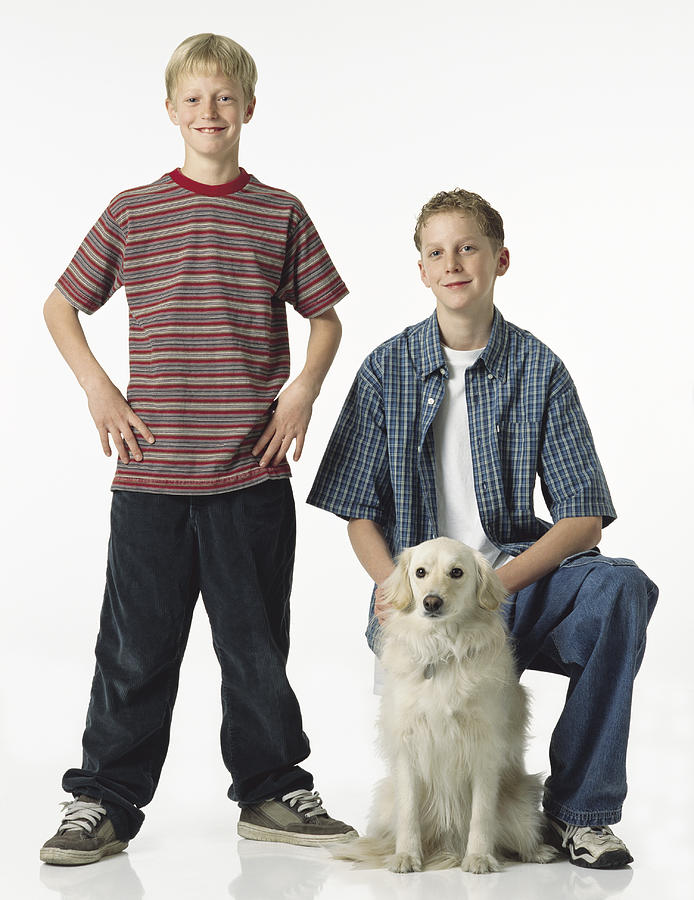 Two Caucasian Blonde Brothers With One Standing With Hands On Hips The Other Kneeling With White Retriever Mix Dog Photograph by Photodisc