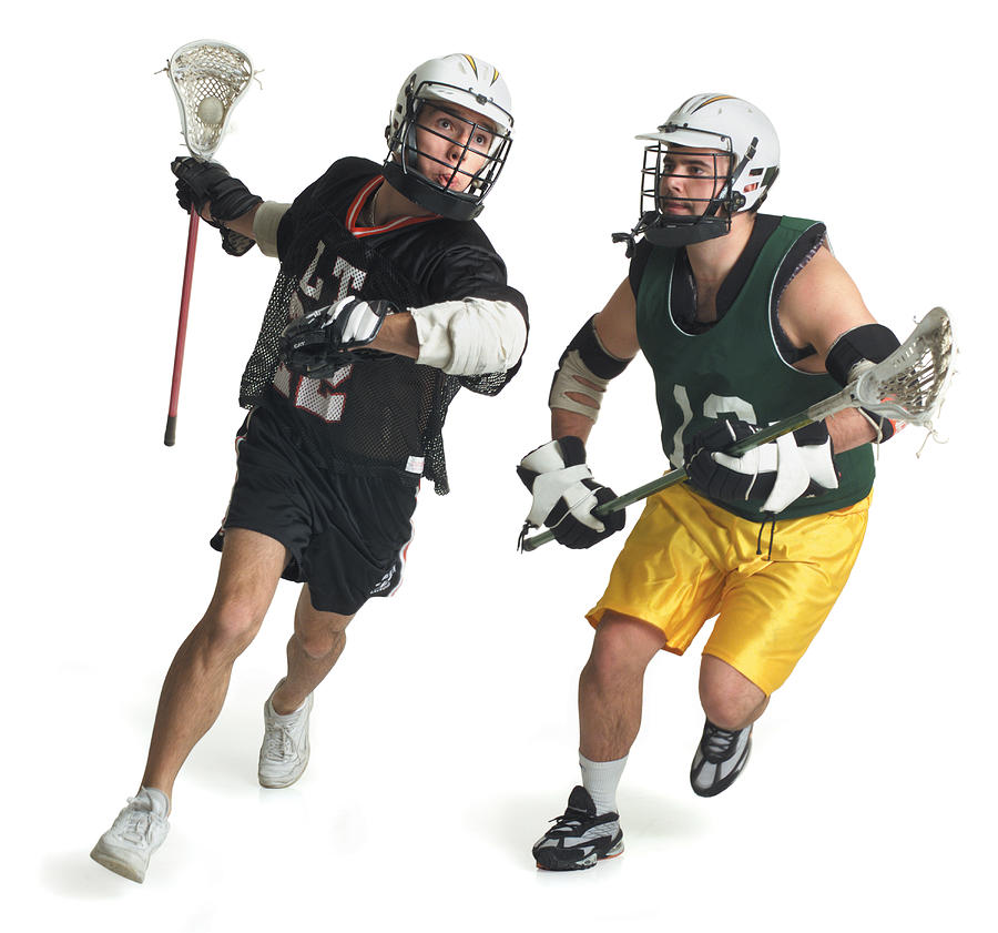 Two Caucasian Male Lacrosse Players From Opposite Teams Run As The One In The Green Jersey Tries To Block The One In Black Photograph by Photodisc