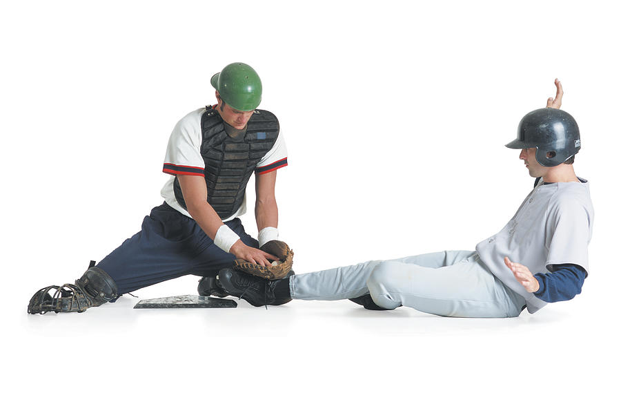 Two Caucasian Men Are Dressed In Baseball Uniforms As One In A Catcher Vest Tags The Other Wearing A Batter Helmet Out Photograph by Photodisc