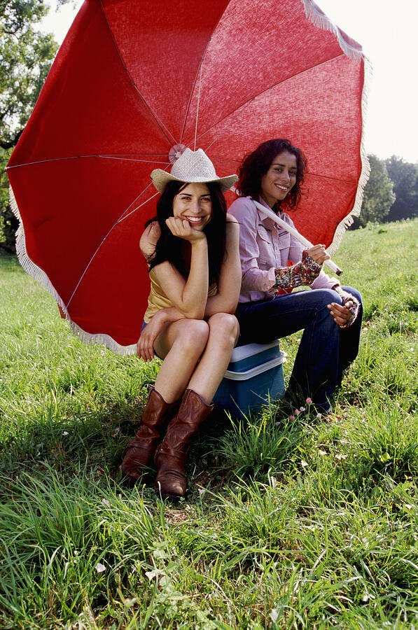 Two Cool Women Sitting Side by Side Underneath a Parasol Photograph by Vincent Besnault
