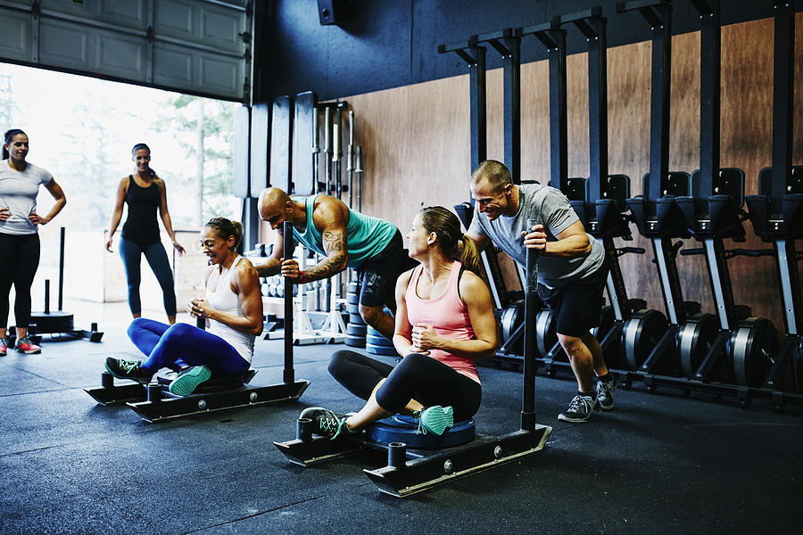 Two couples preparing to race during workout Photograph by Thomas Barwick
