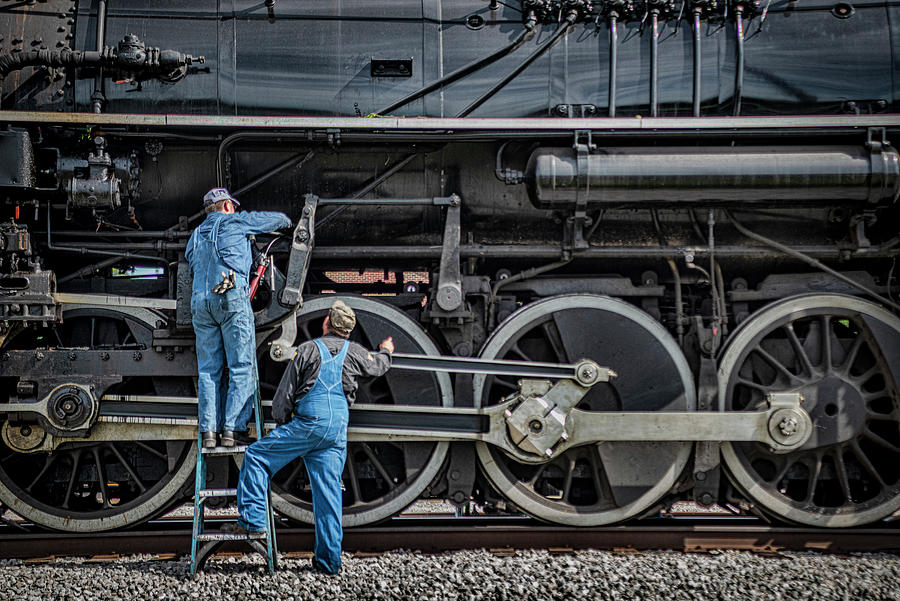 Two crew members work on Nickel Plate Road steam locomotive 765 Photograph by Jim Pearson