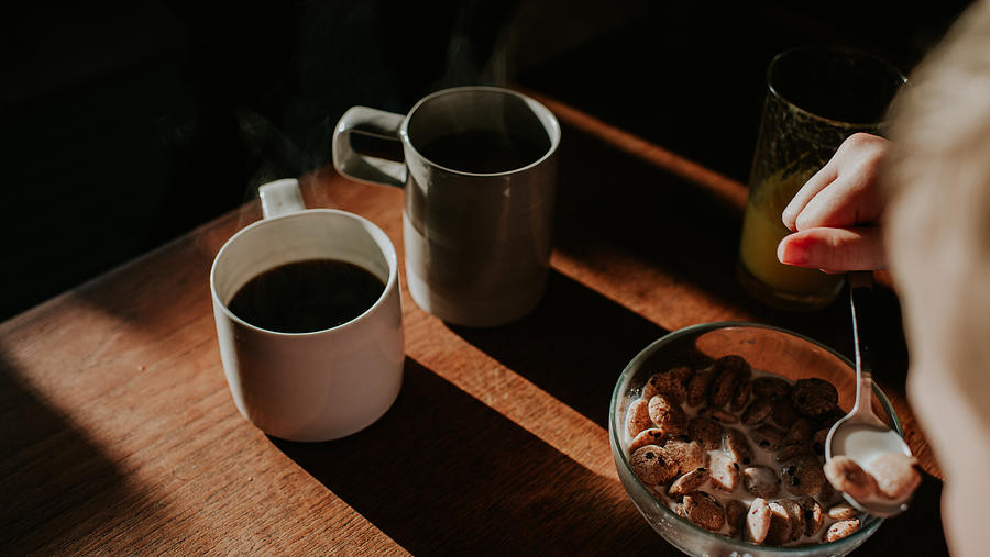 Two cups of coffee on a wooden table with a bowl of breakfast cereal Photograph by Catherine Falls Commercial