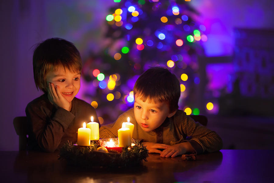 Two cute boys, watching candles burning Photograph by Tatyana Tomsickova Photography