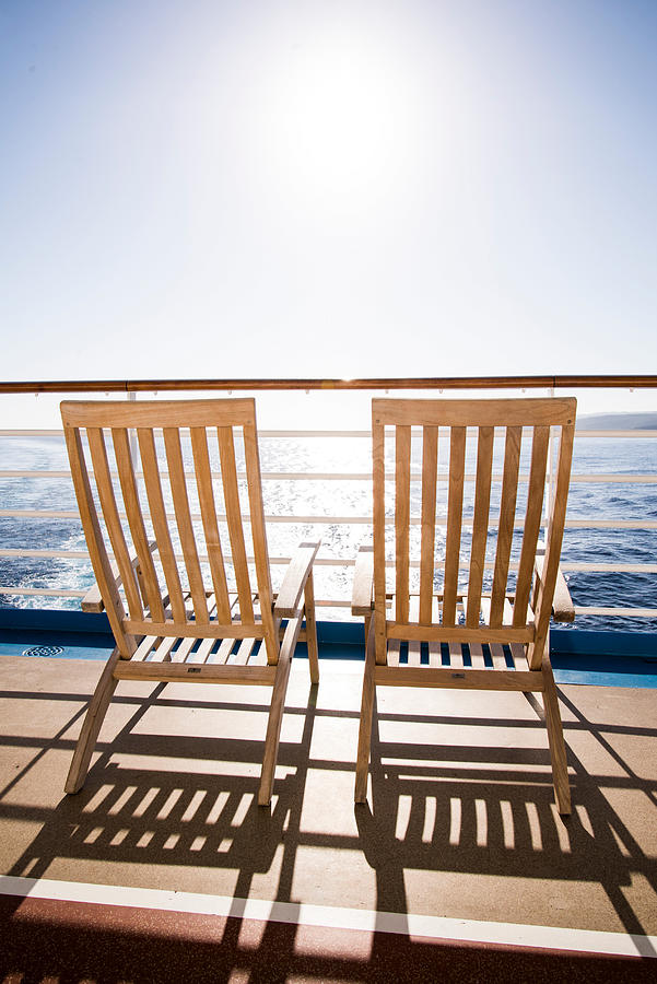 Two deckchairs on cruise ship at sea, Falmouth, Jamaica Photograph by Cultura RF/Rosanna U