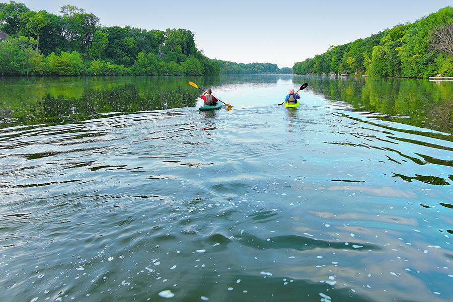 Sports Photograph - Two friends kayaking on tranquil river 3 by James Brey