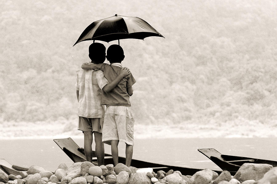 Two friends standing on river bank under umbrella Photograph by Mohammad Mustafizur Rahman