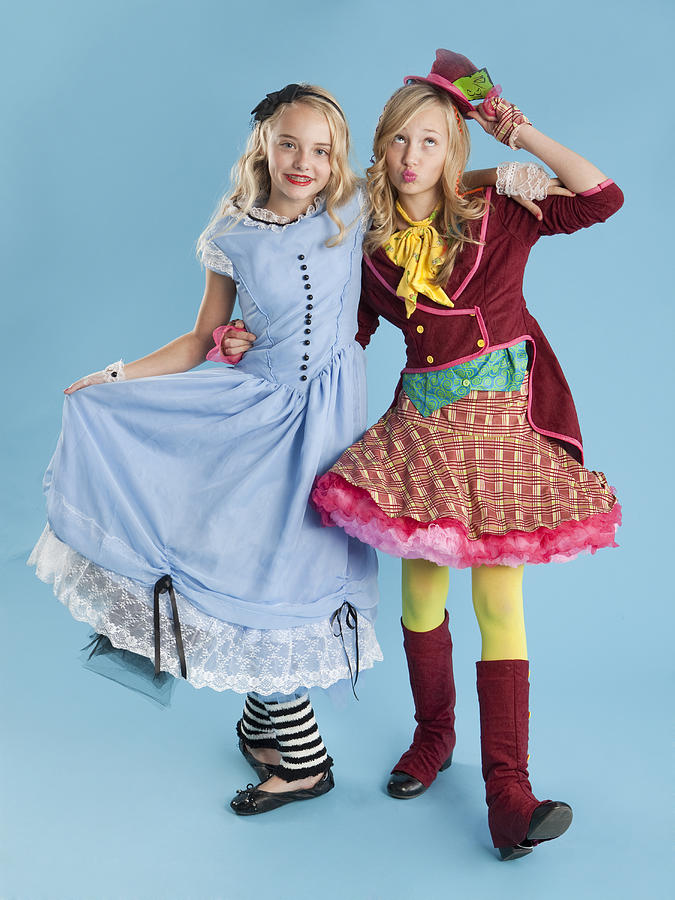Two girls (10-11) in Alice in Wonderland costumes for Halloween Photograph by Nicole Hill Gerulat