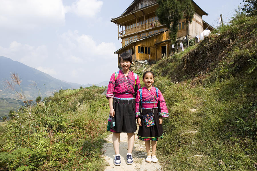 Two girls (13-15) of Yao mountain tribe smiling, portrait Photograph by Buena Vista Images