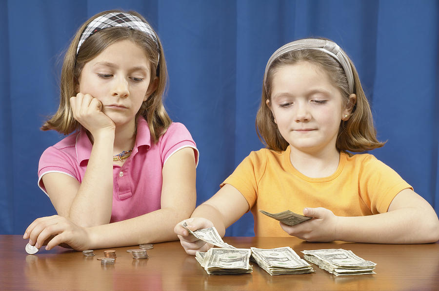Two Girls Counting Money Photograph by David McGlynn