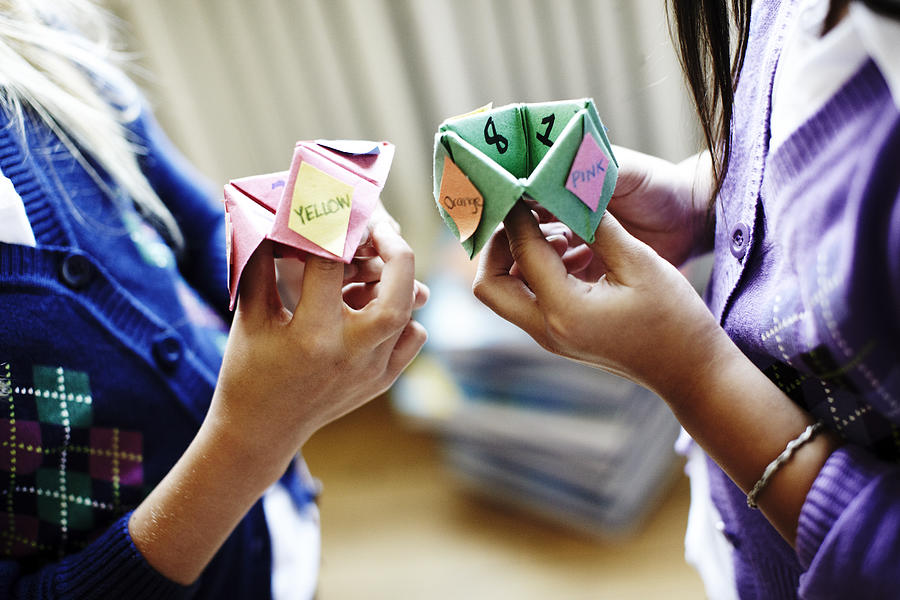 Two girls playing origami fortune game Photograph by Robert Deutschman