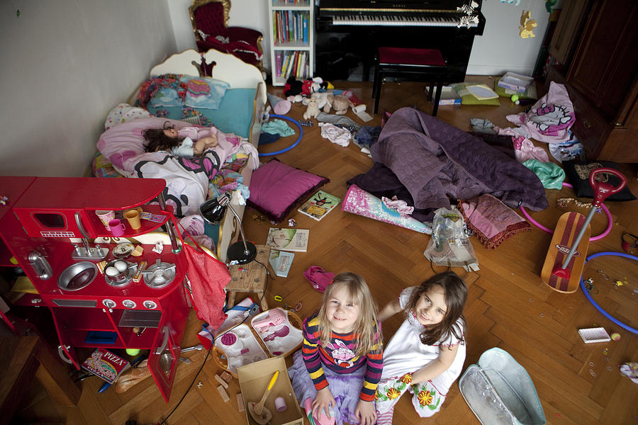 Two Girls Smiling Into The Camera In Chaos Room Photograph by Frank Rothe