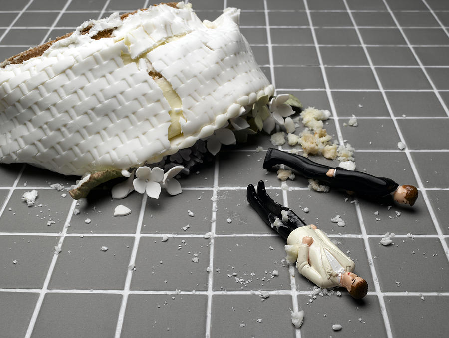 Two groom figurines lying at destroyed wedding cake on tiled floor Photograph by Jeffrey Hamilton