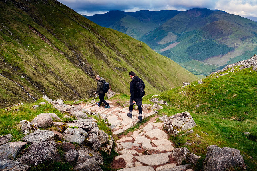 Two hikers walking down a path Photograph by © Peter Lourenco