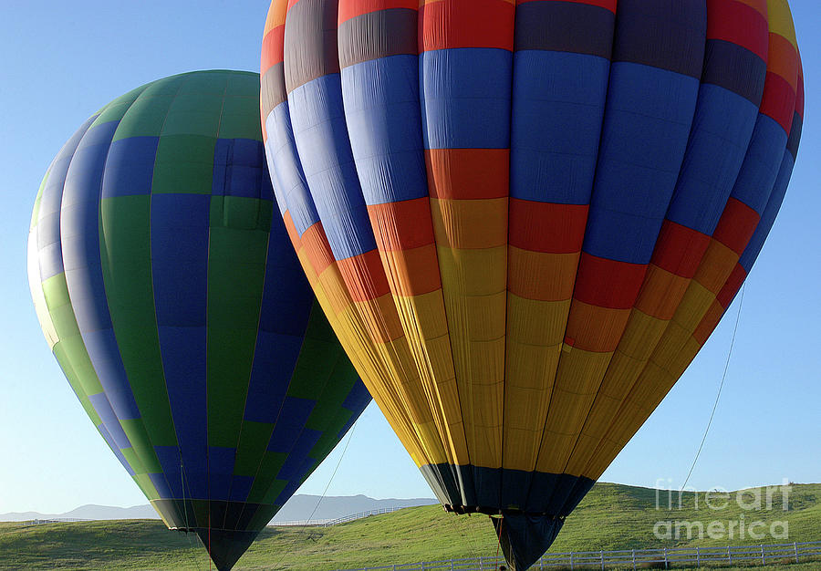 Two hot air balloons are ready to take off.  Photograph by Gunther Allen