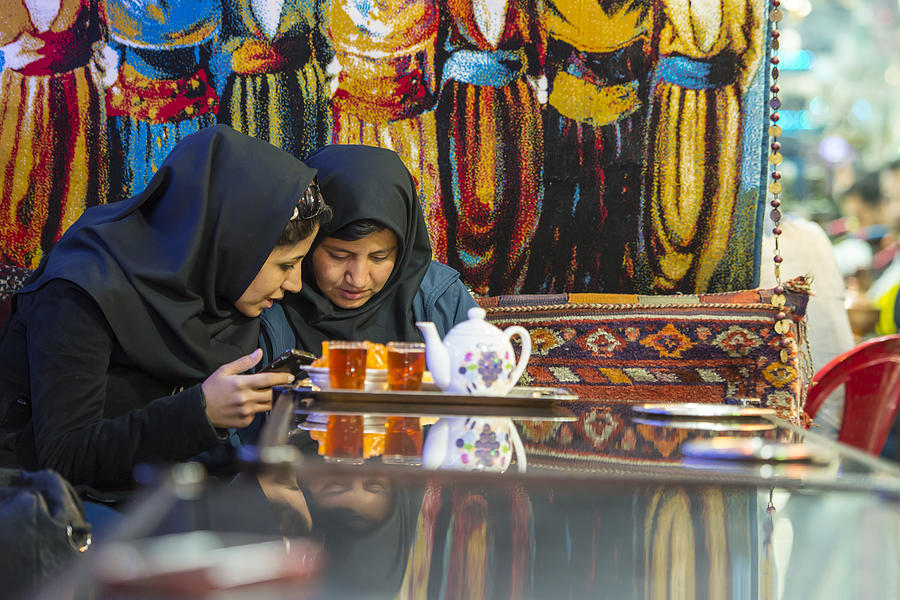 Two Iranian women in a traditional tea house, Isfahan, Iran Photograph by Guenterguni