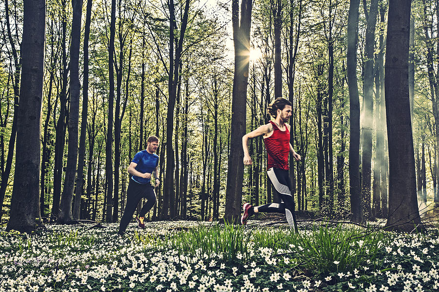 Two male adults running in the forest in the springtime. Photograph by David Trood