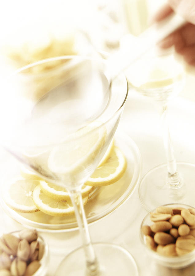 Two martini glasses,  nuts and slices of lemon. Photograph by Luk Thys