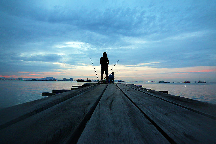 Two men fishing during sunrise Photograph by Omar Shamsuddin