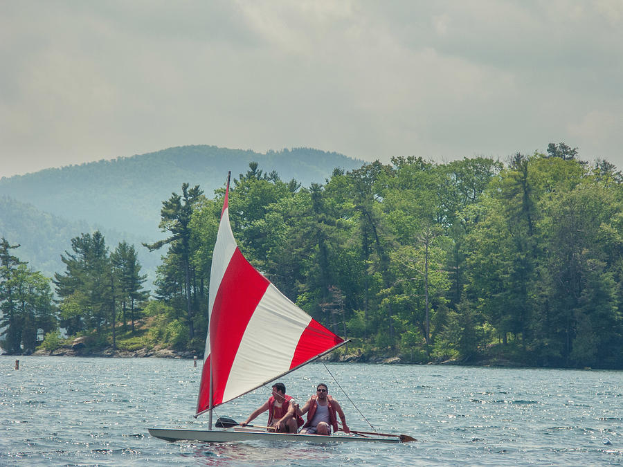 Two men in a small sailboat on Lake George, New York, USA Photograph by Heshphoto