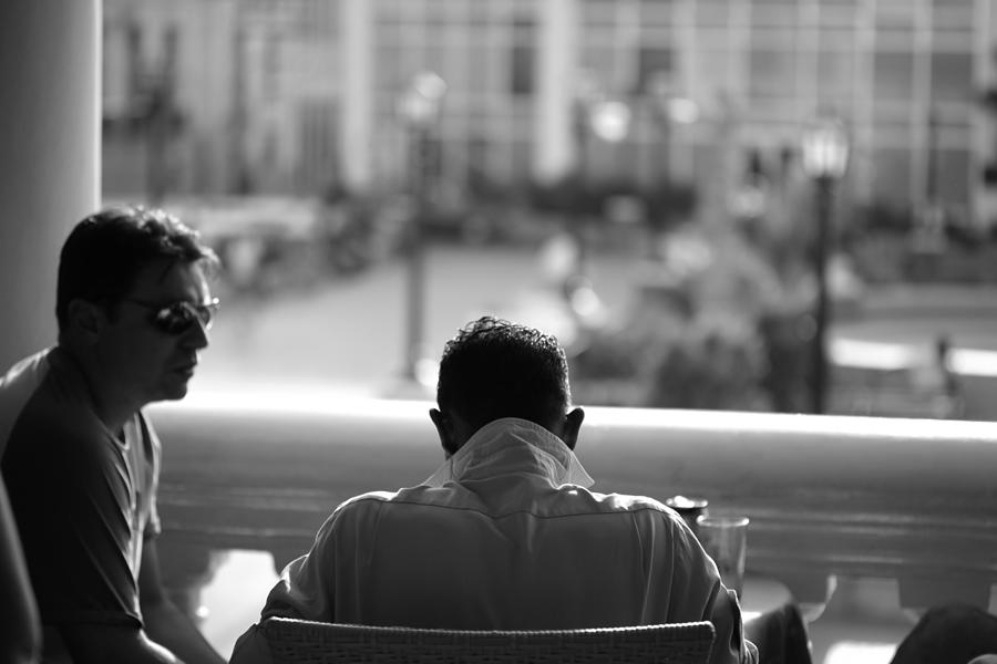 Two men sitting in a restaurant- Santiago de Cuba Photograph by Lubilub