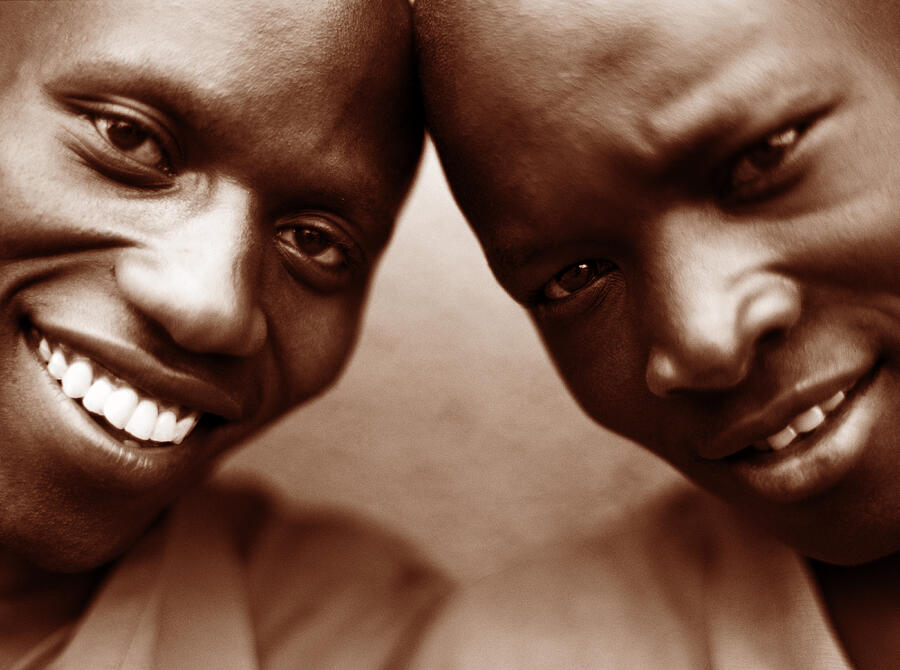 Two men smiling, close-up (sepia tone) Photograph by David Sacks