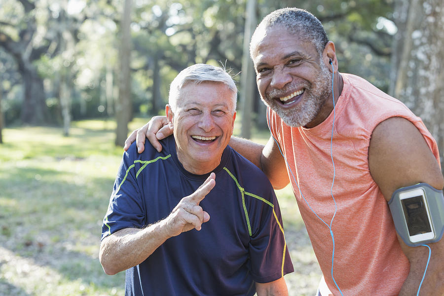 Two multi-ethnic senior men exercsing in the park Photograph by Kali9