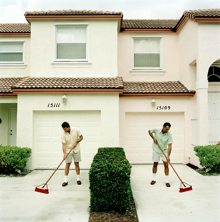 Two neighbours sweeping driveways Photograph by Kelvin Murray