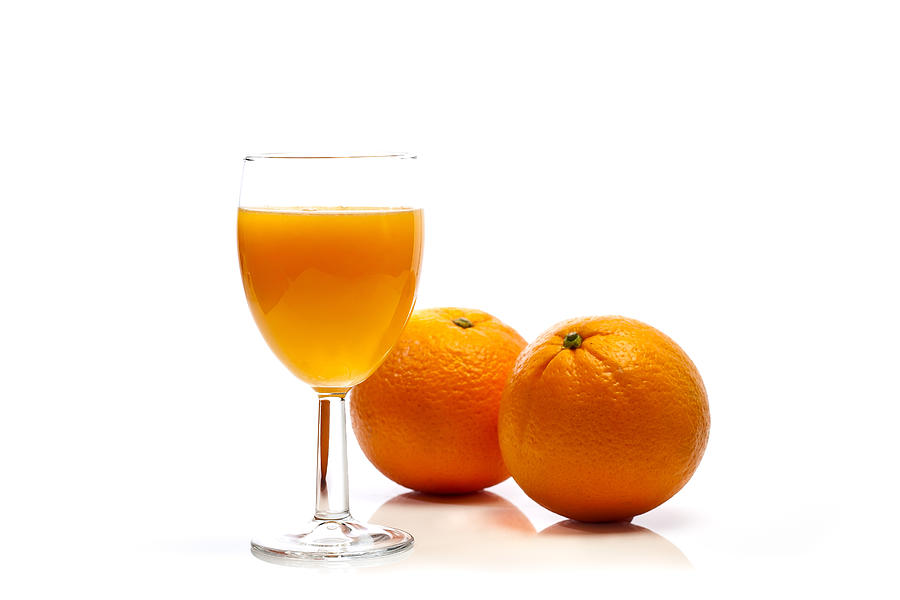 Two oranges and glass of orange juice Photograph by Henrique Feliciano Photography