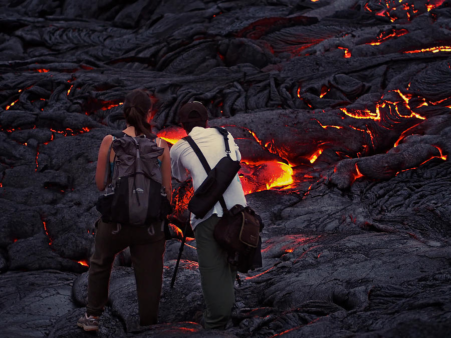Two people photographing lava streams in Hawaii Photograph by Photograph by Michael Schwab