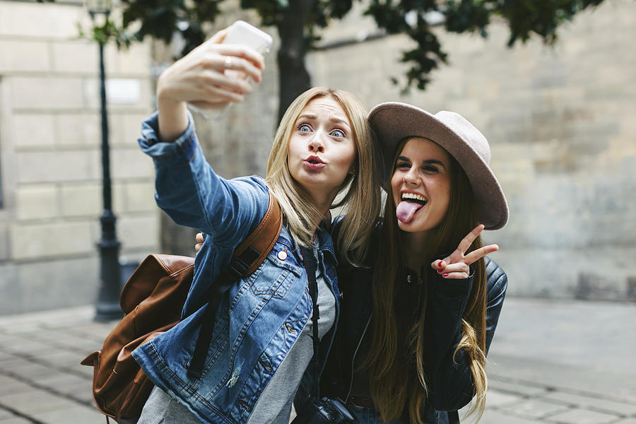 Two playful young women taking a selfie Photograph by Westend61
