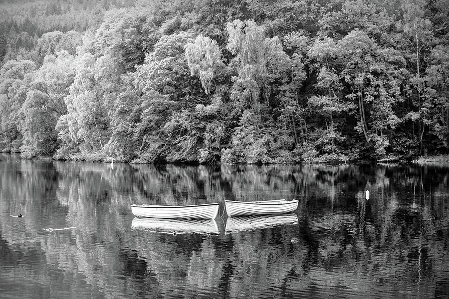 Two Rowboats in the Lake in Black and White Photograph by Debra and Dave Vanderlaan