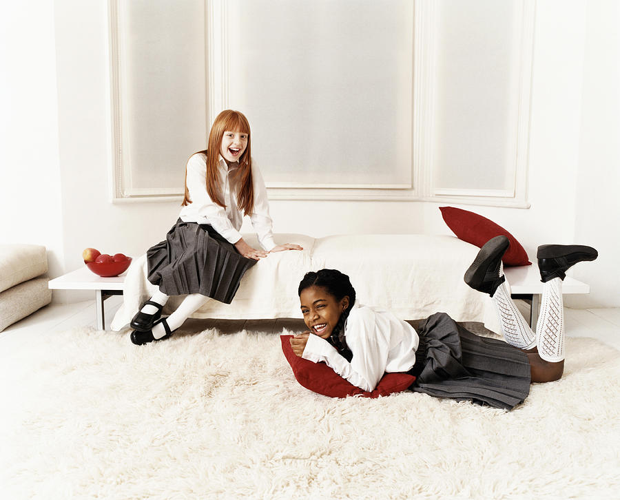 Two Schoolgirls Messing About in a Living Room Photograph by Lottie Davies