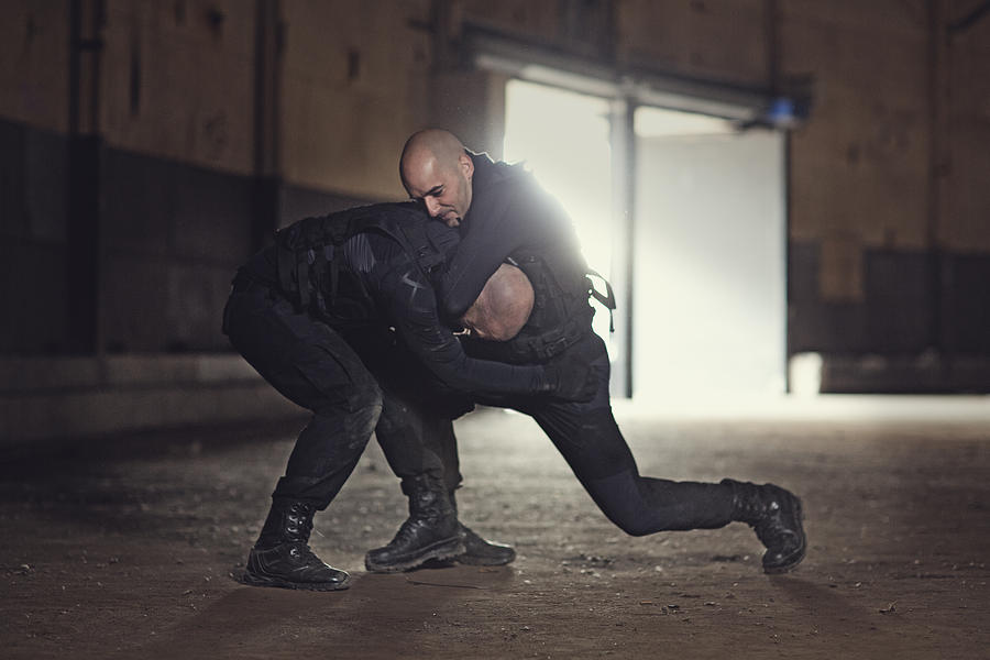 Two shaven headed swat team members fighting in abandoned warehouse Photograph by Lorado