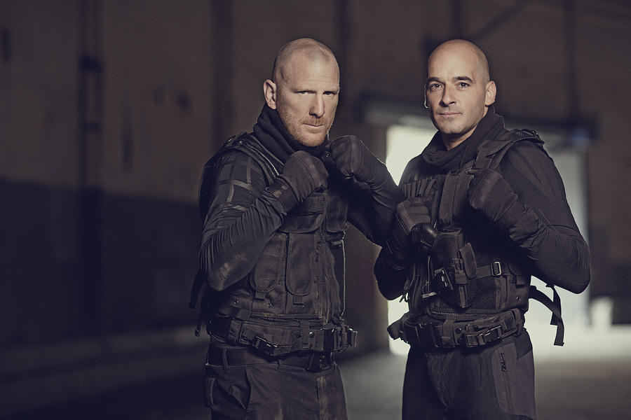 Two shaven headed swat team members posing in abandoned warehouse Photograph by Lorado