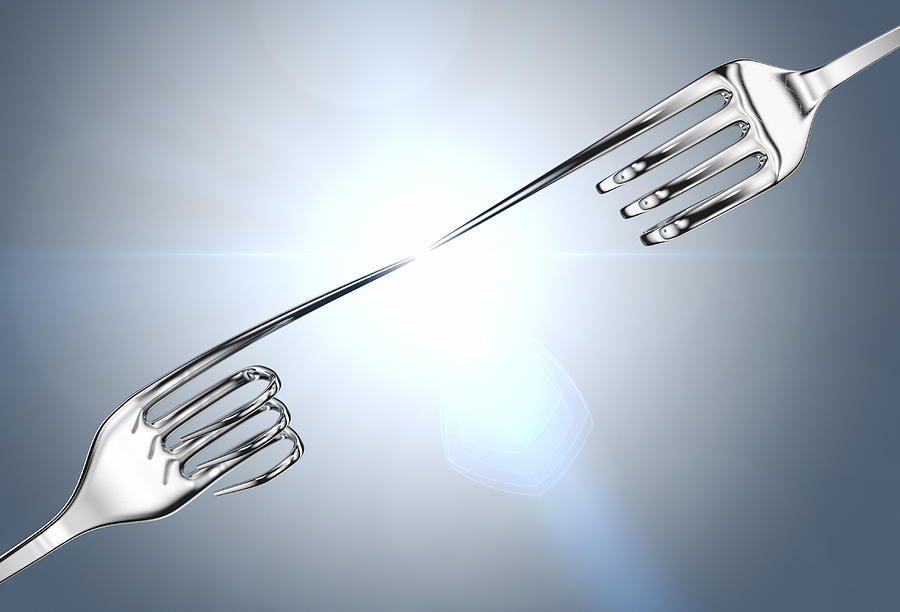 Two silver forks reaching out to each other Photograph by Atomic Imagery