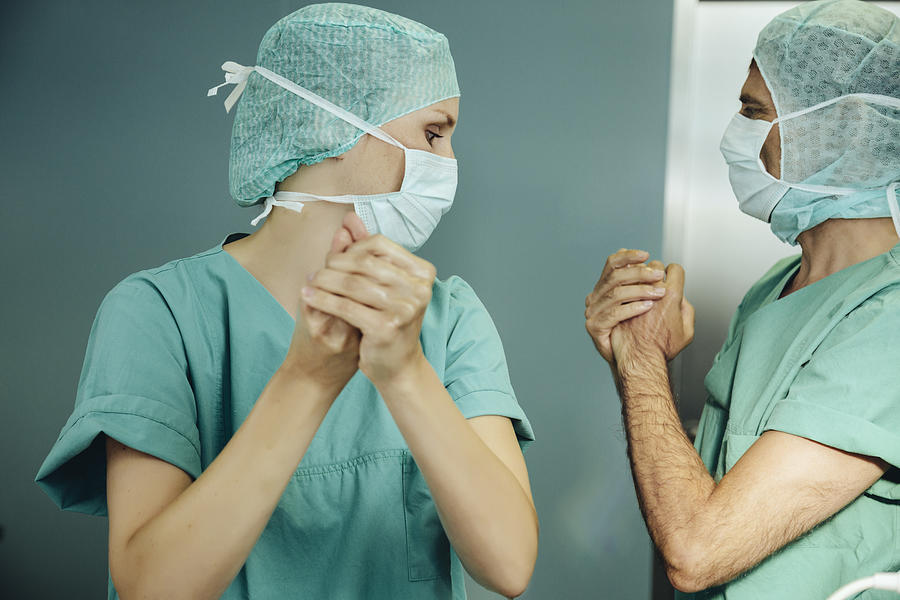 Two surgeons disinfecting their hands before surgery Photograph by Westend61
