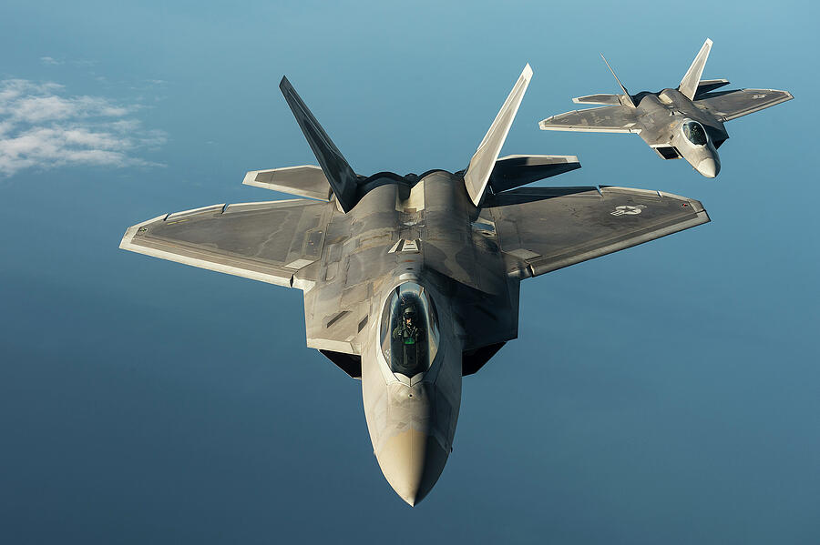Two U.S. Air Force F-22 Raptors from the 95th Fighter Squadron Photograph by Lawrence Christopher