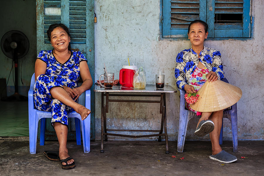 Two Vietnamese women drinking coffee together, Mekong River Delta, Vietnam Photograph by Hadynyah