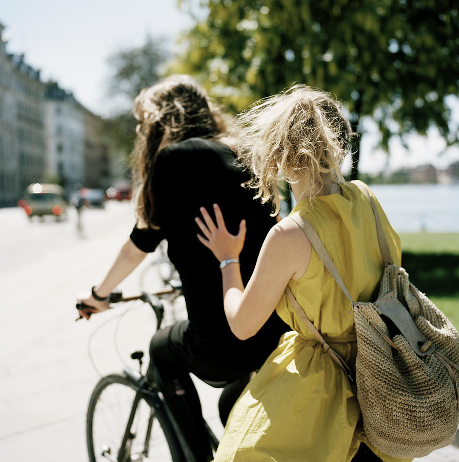 Two Women Riding Same Bike I City Photograph by Solskin