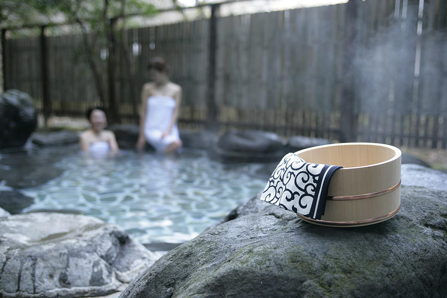 Two women soaking in hot spring Photograph by Traveling Spa