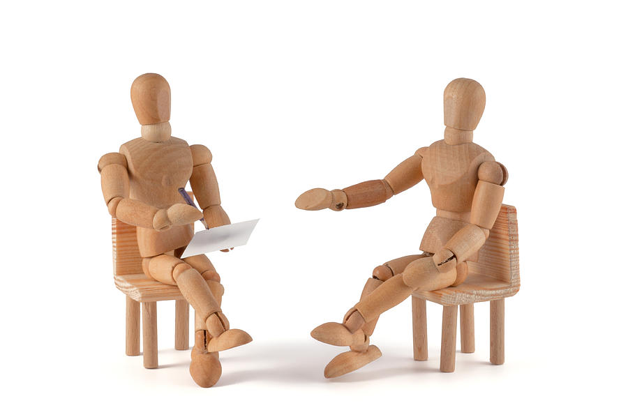 Two wooden mannequin placed as if having a conversation Photograph by Kerrick