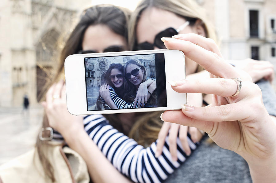 Two young female friends taking a self portrait, Valencia, Spain Photograph by Andy Smith