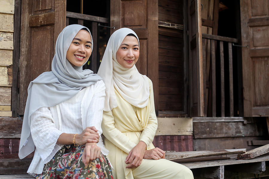 Two Young Malay Muslim Women Sitting Together Photograph by Faidzzainal