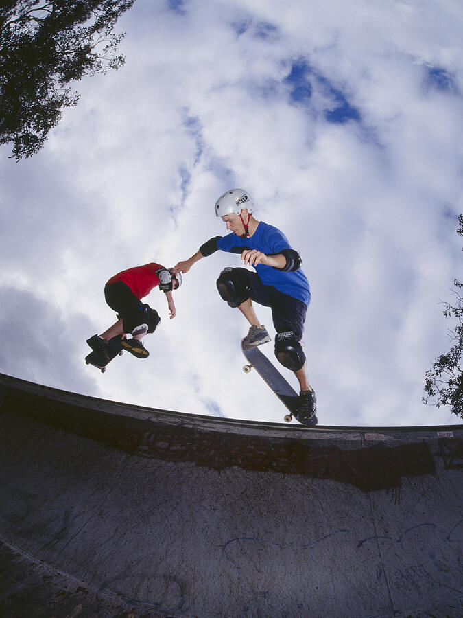 Two young men skateboarding on ramp Photograph by Dex Image